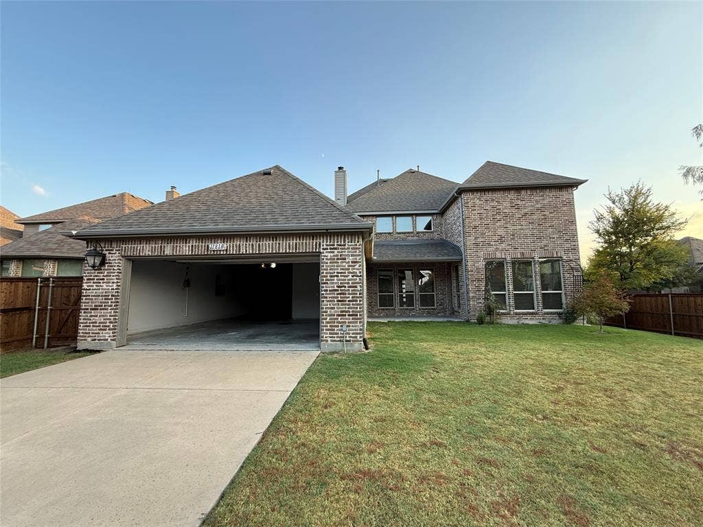 11818 Antler Drive, Frisco, TX 75035 Brick exterior with a multi-level roofline, attached garage, and multiple large windows