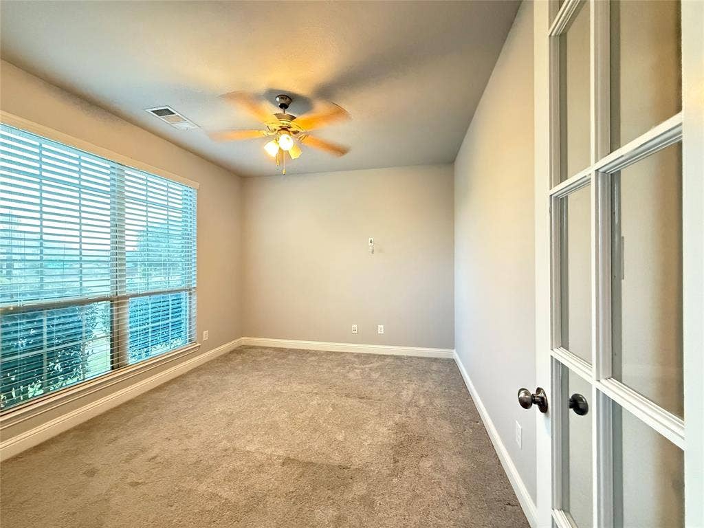 11818 Antler Drive, Frisco, TX 75035 Recessed window with blinds, ceiling fan with integrated lighting, carpeted flooring, and French doors with dark hardware