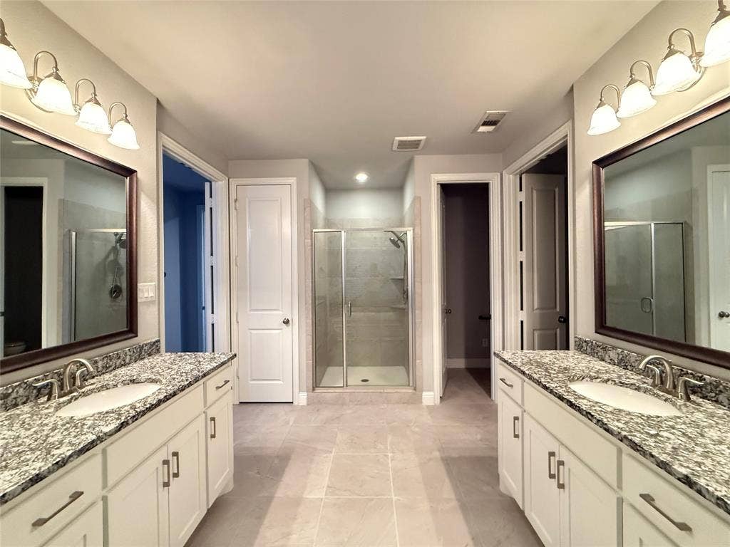 11818 Antler Drive, Frisco, TX 75035 Dual white vanities with granite countertops, undermount sinks, and chrome fixtures