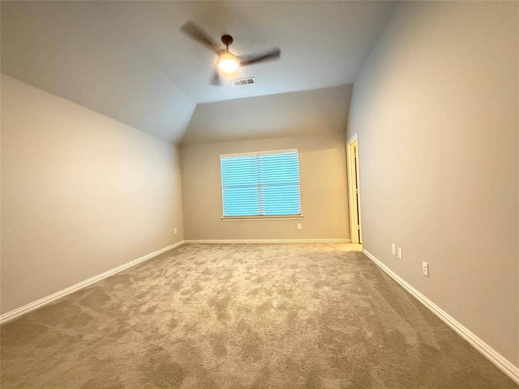 11818 Antler Drive, Frisco, TX 75035 Vaulted ceiling, ceiling fan, carpeted flooring, window with blinds, and painted walls