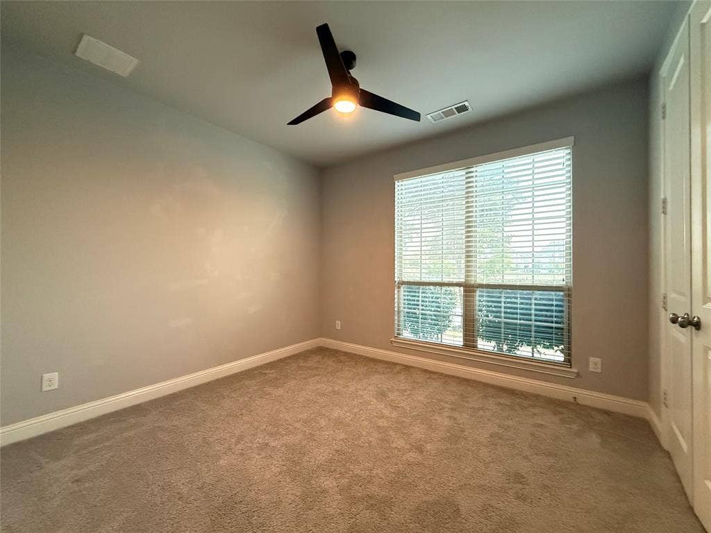 11818 Antler Drive, Frisco, TX 75035 Neutral wall color, plush carpet flooring, ceiling fan with integrated lighting, window with blinds, and white trim