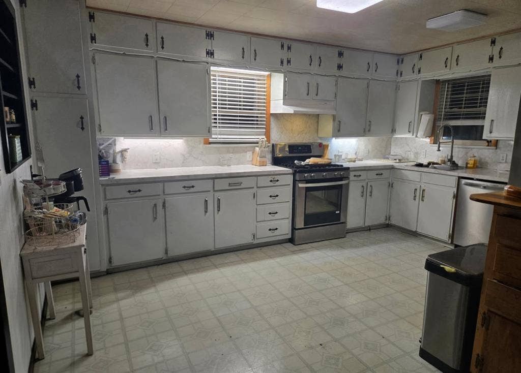 6220 W Highway 199, Springtown, TX 76082 Kitchen featuring white cabinetry, light-toned countertops, a stainless steel range, and a stainless steel dishwasher