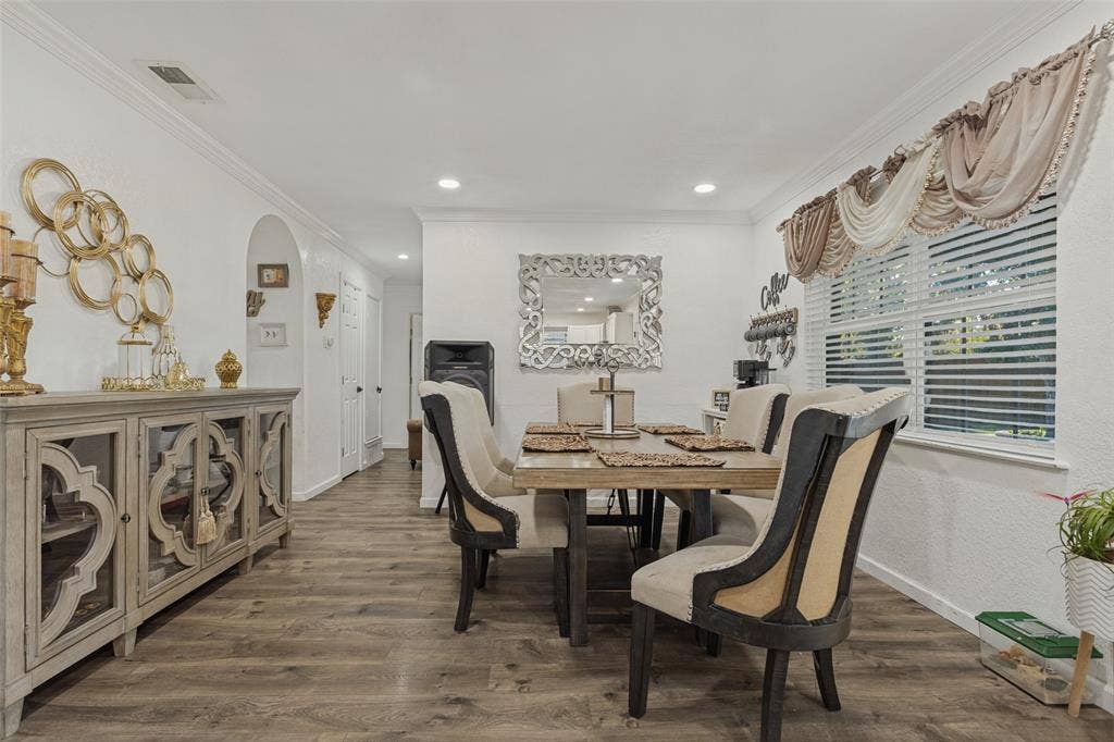 1522 Carroll Drive, Garland, TX 75041 Wood-finish flooring, recessed lighting, crown molding, and an arched entry