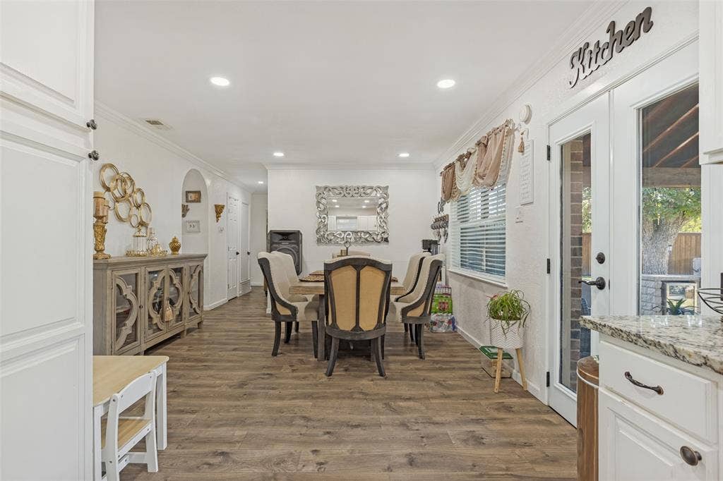 1522 Carroll Drive, Garland, TX 75041 Open-concept dining area featuring wood-finish flooring, recessed lighting, and full-glass French doors