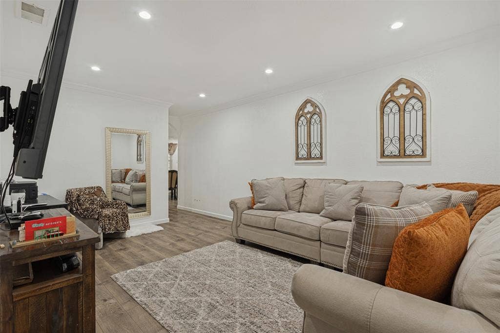 1522 Carroll Drive, Garland, TX 75041 Wood-finish flooring, recessed lighting, and arched wall accents