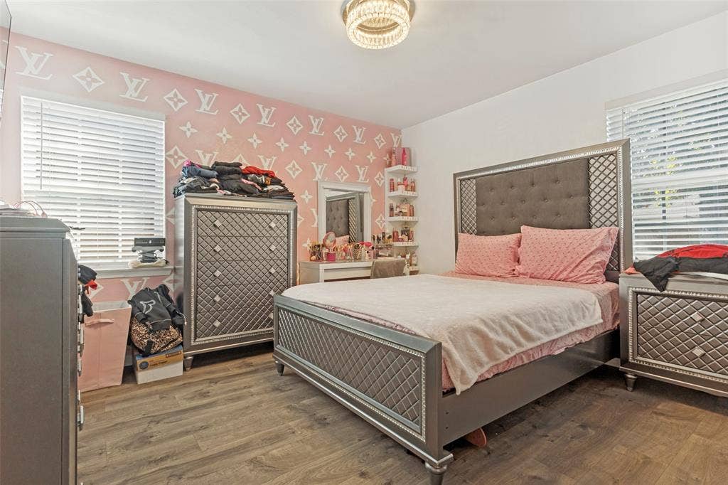 1522 Carroll Drive, Garland, TX 75041 Wood-finish flooring, recessed horizontal window blinds, and built-in wall shelving