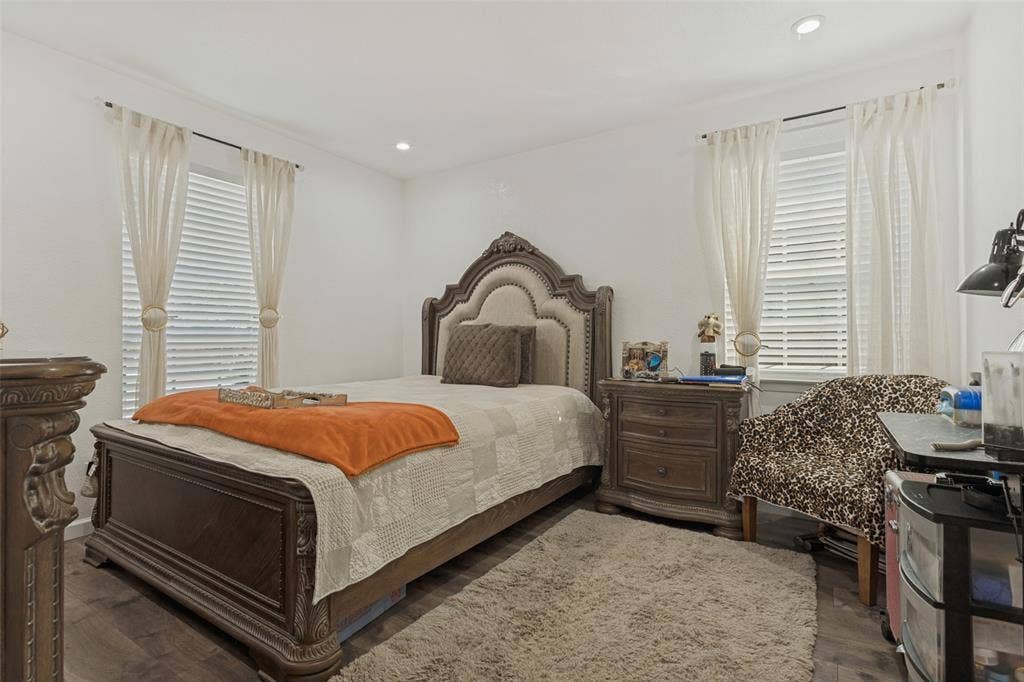 1522 Carroll Drive, Garland, TX 75041 Neutral interior space featuring wood-finish flooring, recessed lighting, and dual windows with horizontal blinds