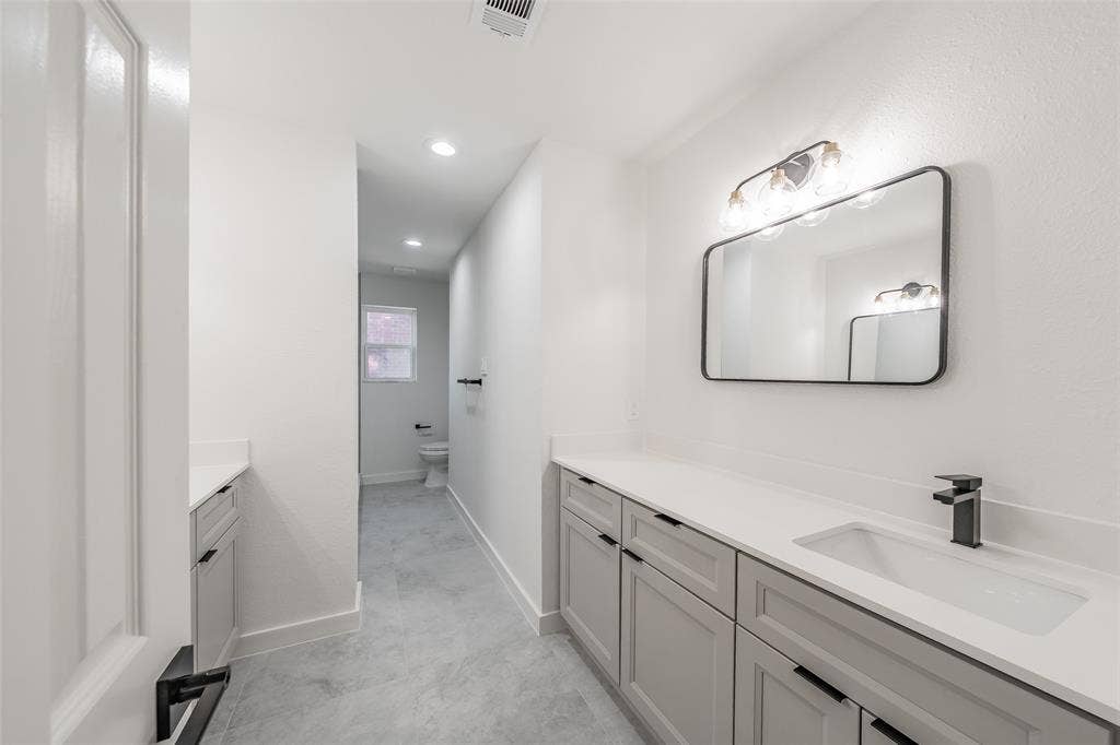 617 Dover Court, Coppell, TX 75019 Two separate vanities with integrated sink with plenty of storage and countertop, and matte black faucet