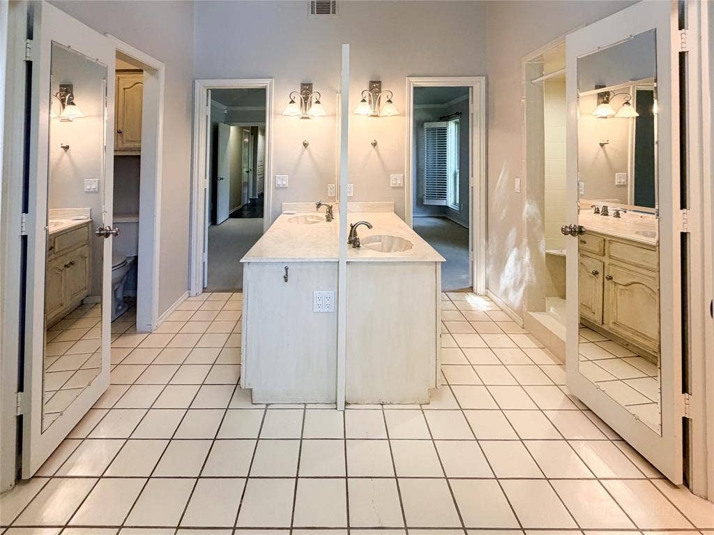 2304 Skipwith Drive, Plano, TX 75023 central island dual sinks with mirror back to back