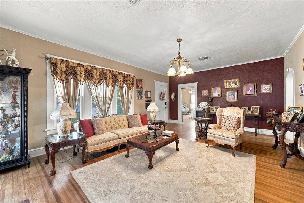 2725 Morrow Avenue, Waco, TX 76707 Hardwood flooring throughout, crown molding, and a chandelier light fixture