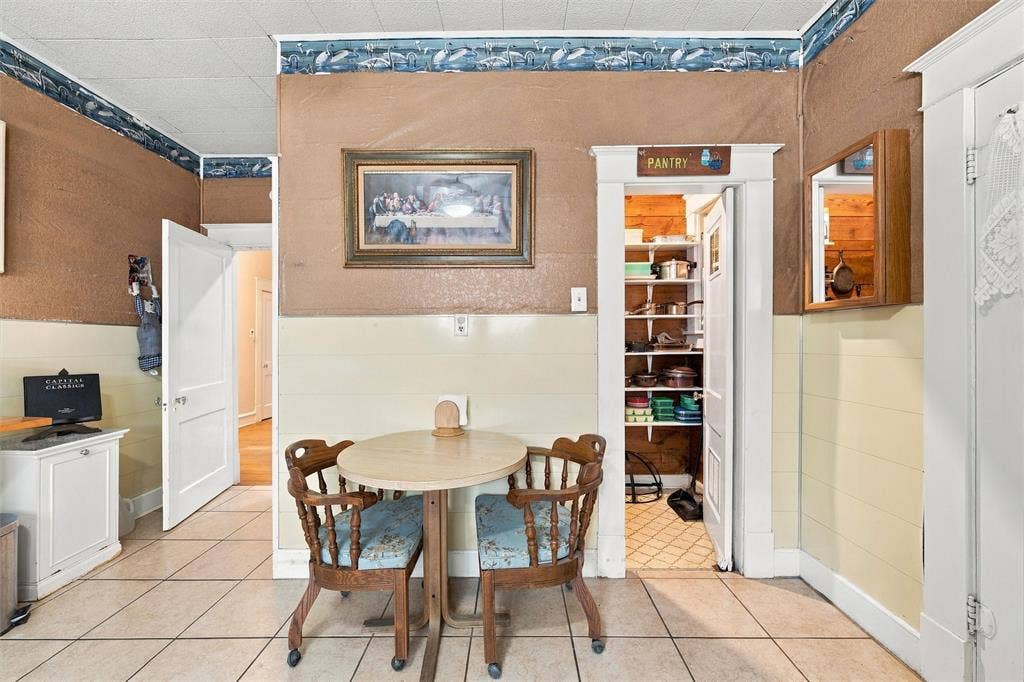 2725 Morrow Avenue, Waco, TX 76707 Tile flooring, built-in pantry with shelving, paneled wainscoting, and white trim throughout