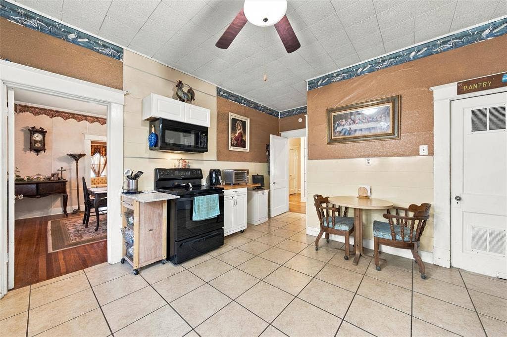 2725 Morrow Avenue, Waco, TX 76707 Tile flooring, a ceiling fan, and white upper cabinetry