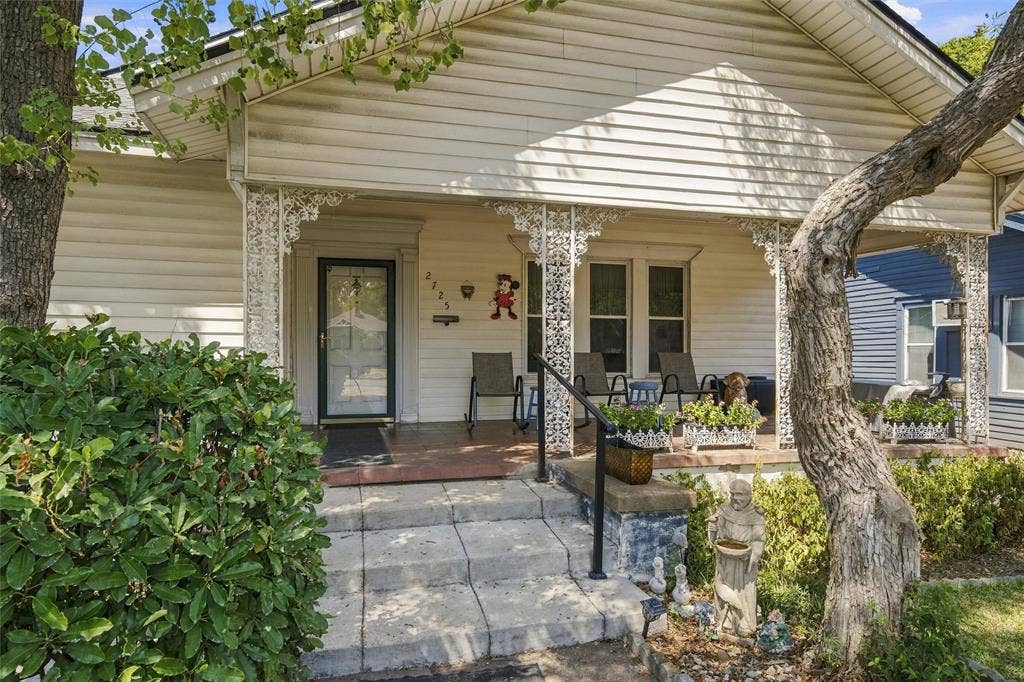 2725 Morrow Avenue, Waco, TX 76707 Covered front porch with decorative wrought iron support columns, concrete steps, and a black metal handrail