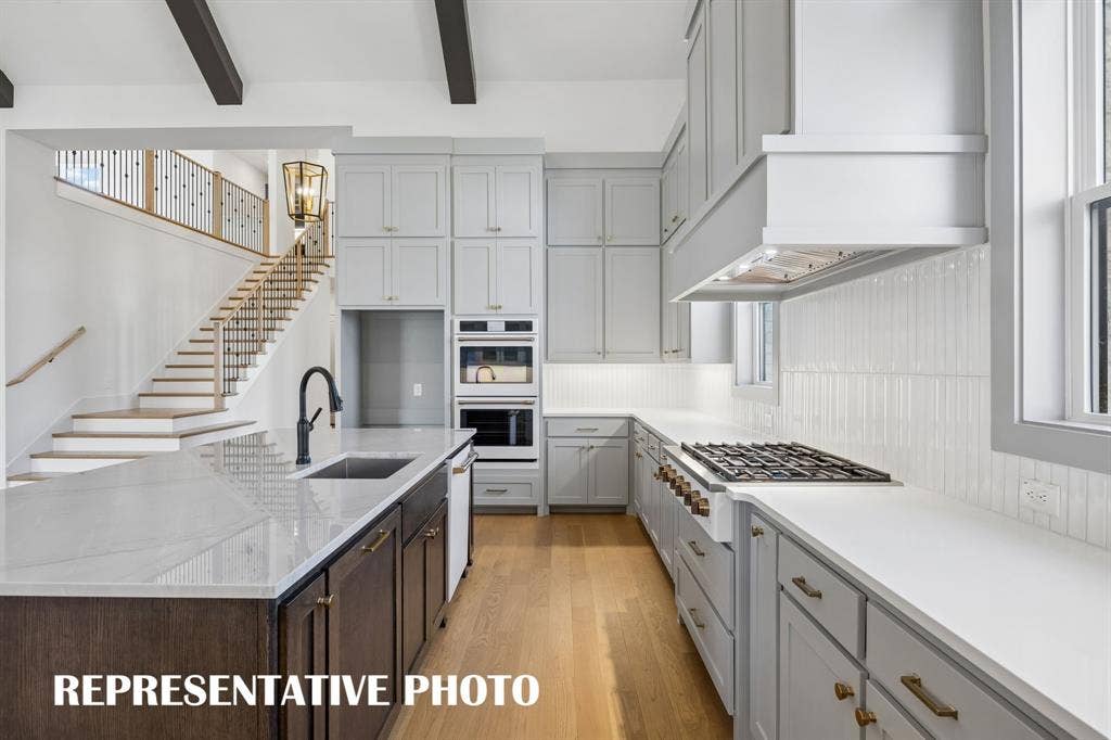 Beautiful cabinetry, gorgeous countertops and designer backsplash effortlessly pair with top of the line, contemporary appliances to create a kitchen for the ages!  REPRESENTATIVE PHOTO