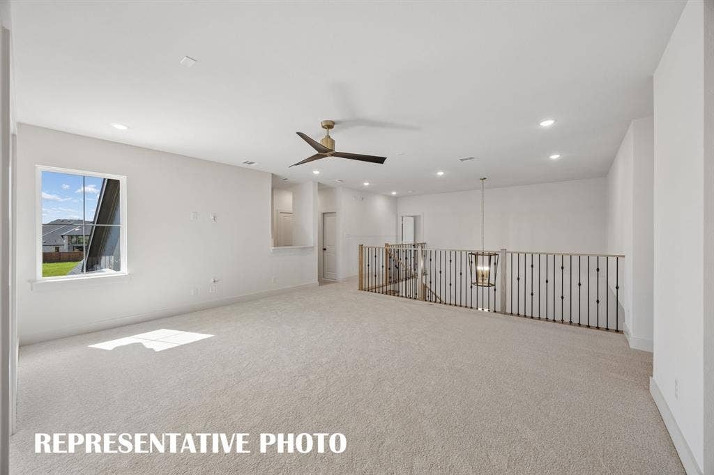 Whether hosting a big game day party or family game night, this spacious game room paired with adjacent media room creates the ultimate family entertainment zone!  REPRESENTATIVE PHOTO