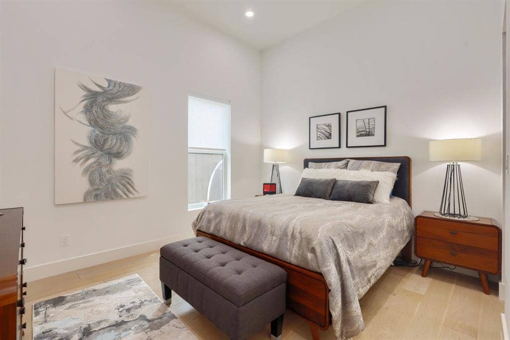 3950 Beechwood Lane, Dallas, TX 75220 Floor 1 Vaulted ceiling, recessed lighting, light wood-finish flooring, and a single window with a roller shade