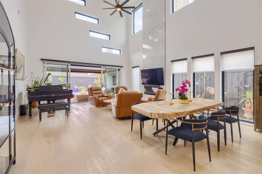 3950 Beechwood Lane, Dallas, TX 75220 Soaring ceilings with transom windows, wood-finish flooring, and an integrated fireplace feature