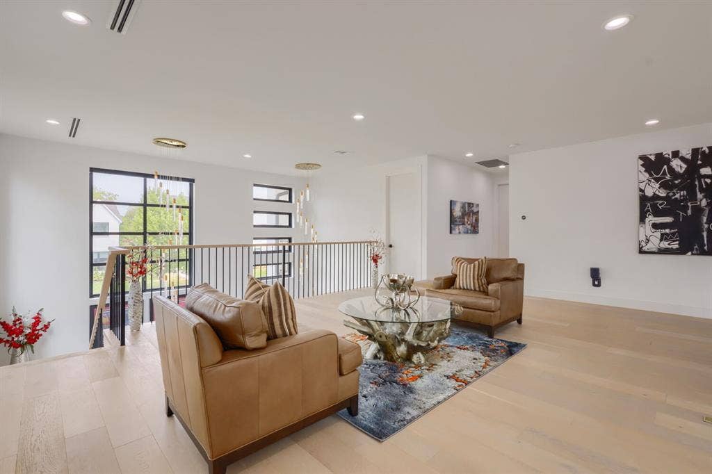 3950 Beechwood Lane, Dallas, TX 75220 Flex area Recessed lighting, light wood-finish flooring, black-framed windows, and a black metal and wood railing