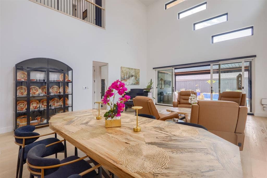 3950 Beechwood Lane, Dallas, TX 75220 Vaulted ceilings with high-set windows, wood-finish flooring, and sliding glass doors