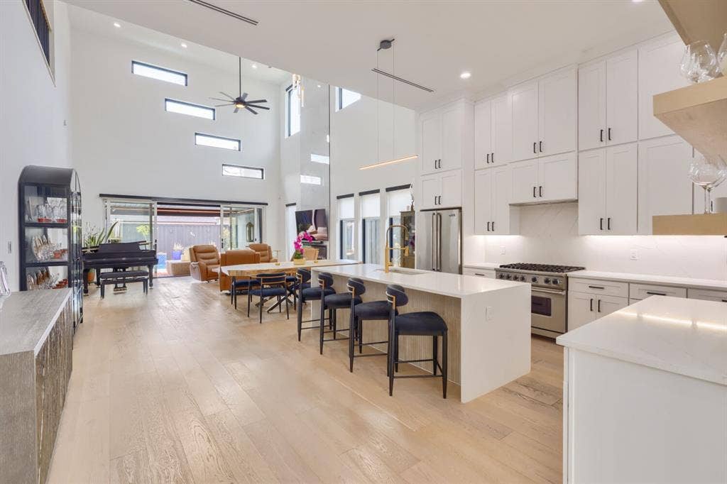 3950 Beechwood Lane, Dallas, TX 75220 Expansive open-concept living space with high ceilings and wood-finish flooring
