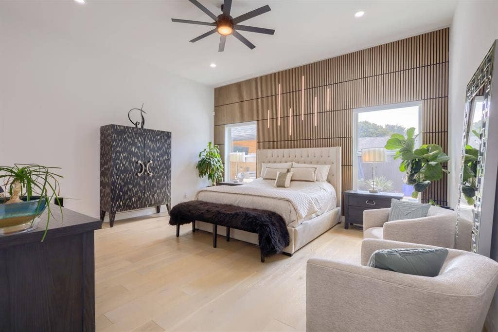 3950 Beechwood Lane, Dallas, TX 75220 Wood-finish flooring, recessed lighting, ceiling fan, and a wood-slatted accent wall with integrated vertical lighting