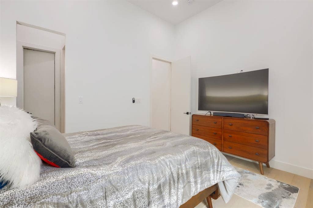 3950 Beechwood Lane, Dallas, TX 75220 Recessed lighting, wood-finish flooring, white walls, and a modern door