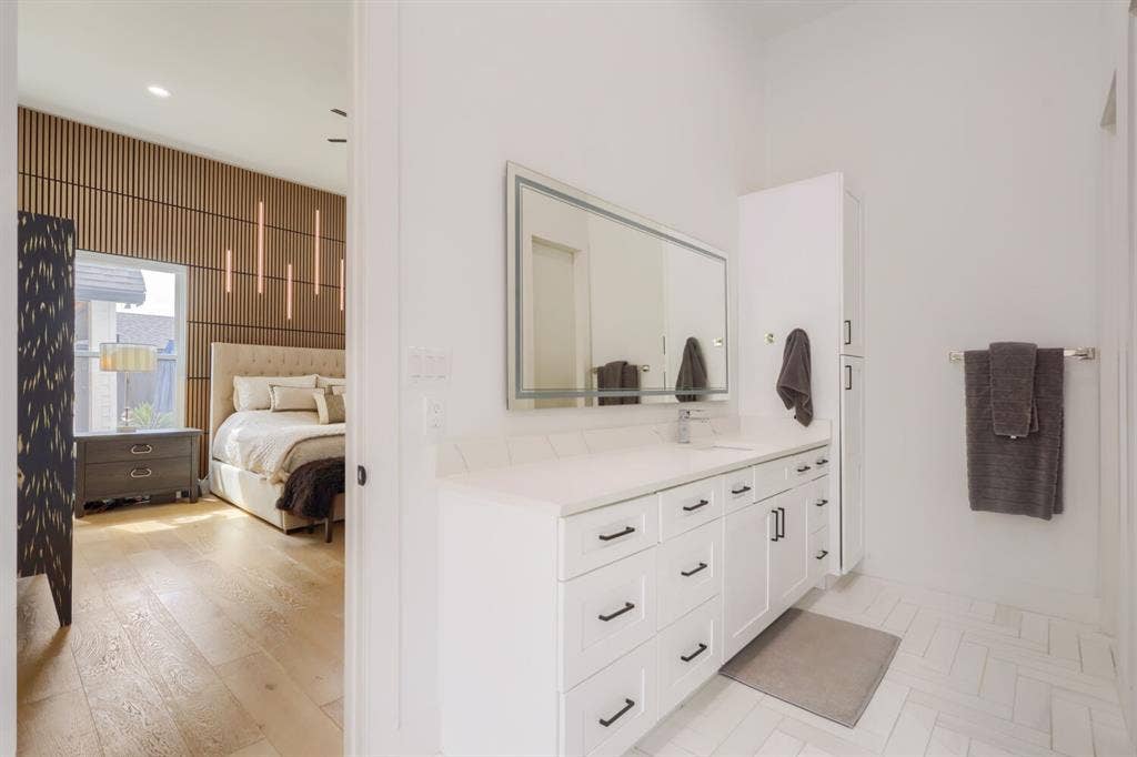 3950 Beechwood Lane, Dallas, TX 75220 White vanity with ample storage, integrated sink, and illuminated mirror