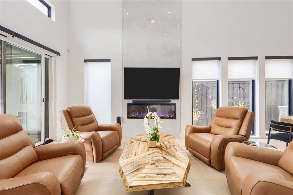 3950 Beechwood Lane, Dallas, TX 75220 Vaulted ceilings, large format tile flooring, built-in faux fireplace, oversized sliding glass door, and clerestory window