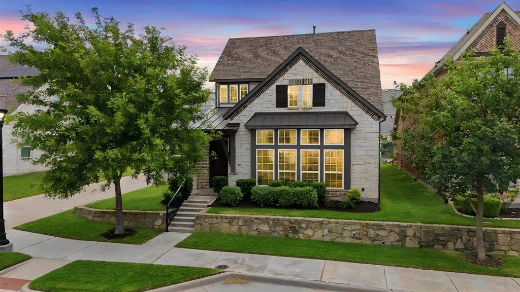 911 Midland Drive, Allen, TX 75013 Stone facade with dark roof shingles, multi-pane windows, and black window shutters