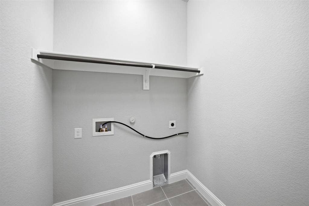 911 Midland Drive, Allen, TX 75013 Laundry area featuring a built-in shelf with hanging rod, durable tile flooring, and utility hookups