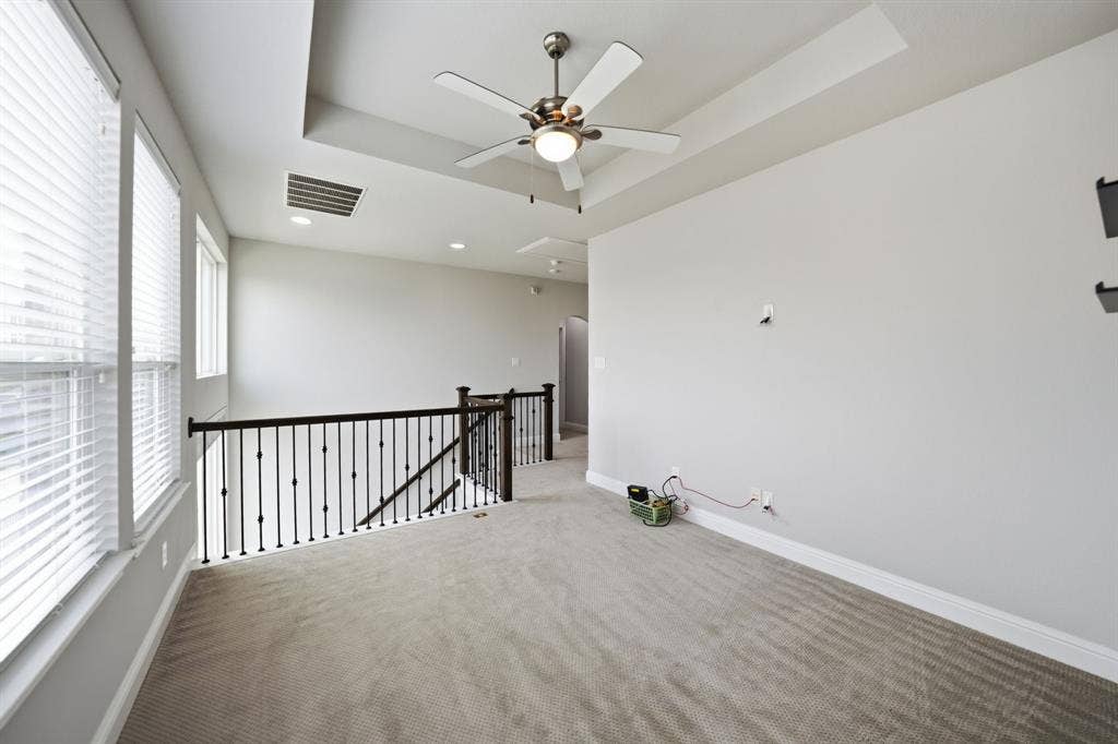 911 Midland Drive, Allen, TX 75013 Carpeted loft area featuring a tray ceiling, recessed lighting, and a ceiling fan
