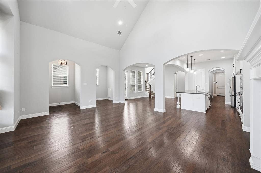 911 Midland Drive, Allen, TX 75013 Vaulted ceiling with a ceiling fan, dark wood-finish flooring, recessed lighting, and arched doorways