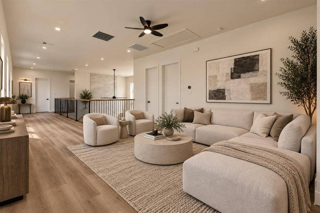 Open-concept living space with wood-finish flooring, recessed lighting, and a ceiling fan