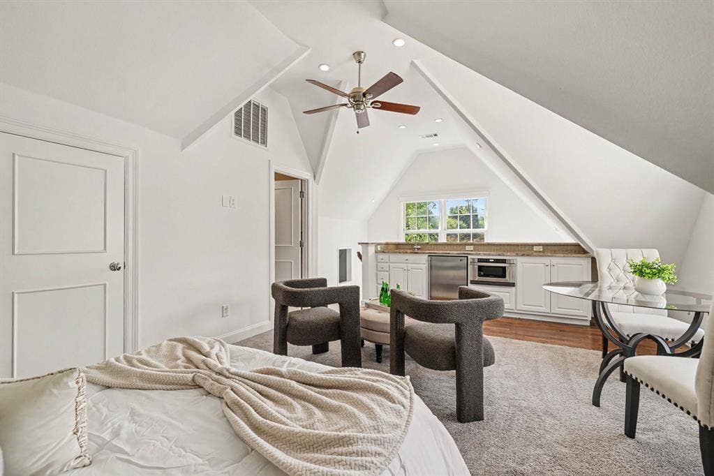 5542 Monticello Avenue, Dallas, TX 75206 Sloped ceilings with recessed lighting, ceiling fan, built-in cabinetry with stainless steel appliances, and a window with exterior views