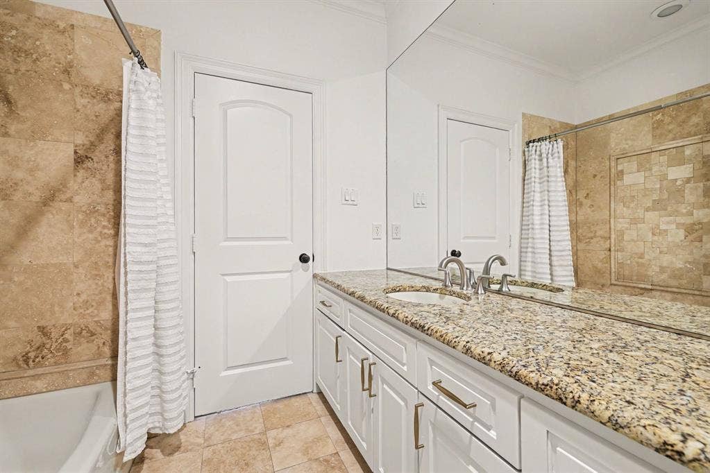 5542 Monticello Avenue, Dallas, TX 75206 Bathroom featuring a white vanity with a granite countertop, dual undermount sinks, and polished chrome faucets