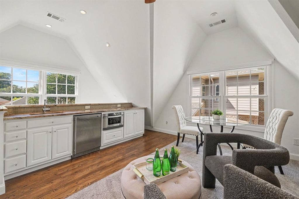 5542 Monticello Avenue, Dallas, TX 75206 Attic space featuring white built-in cabinetry, granite-style countertops, wood-finish flooring, and recessed lighting