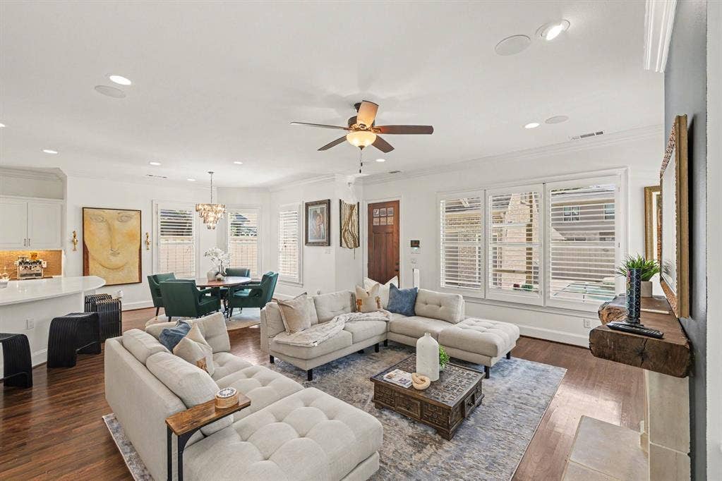 5542 Monticello Avenue, Dallas, TX 75206 Hardwood flooring, recessed lighting, ceiling fan, white plantation shutters, and a built-in fireplace mantel
