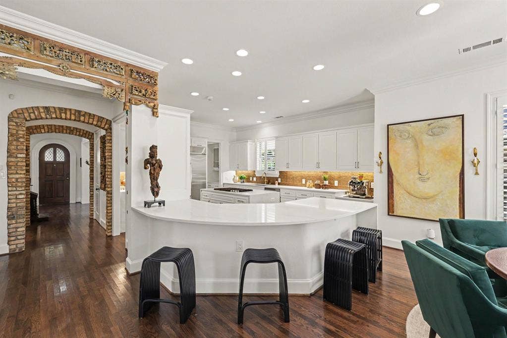 5542 Monticello Avenue, Dallas, TX 75206 Expansive kitchen with a curved island, white cabinetry, integrated stainless steel appliances, and wood-finish flooring