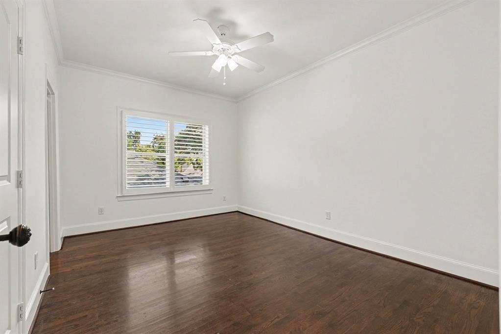5542 Monticello Avenue, Dallas, TX 75206 Hardwood flooring, window with plantation shutters, ceiling fan, crown molding, white painted walls