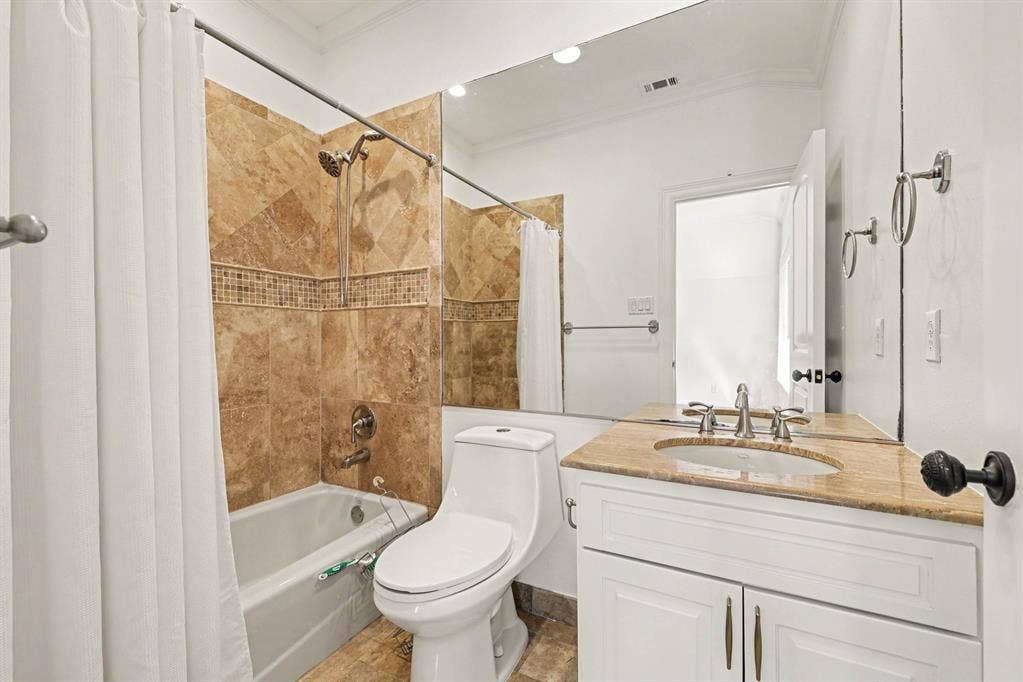 5542 Monticello Avenue, Dallas, TX 75206 White vanity with a stone countertop, an undermount sink, and a large wall-mounted mirror