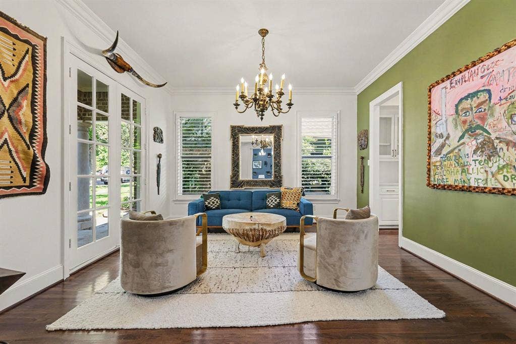5542 Monticello Avenue, Dallas, TX 75206 Hardwood flooring, elegant crown molding, a brass chandelier, and white French doors with transom windows