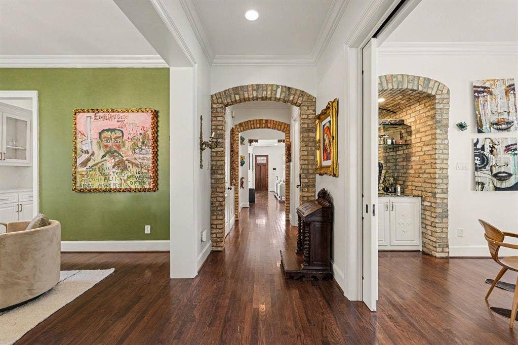 5542 Monticello Avenue, Dallas, TX 75206 Rich wood-finish flooring, brick archways, white crown molding, and recessed lighting