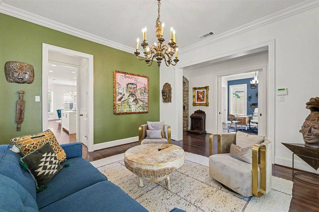 5542 Monticello Avenue, Dallas, TX 75206 Hardwood flooring, crown molding, and a decorative chandelier illuminate this space