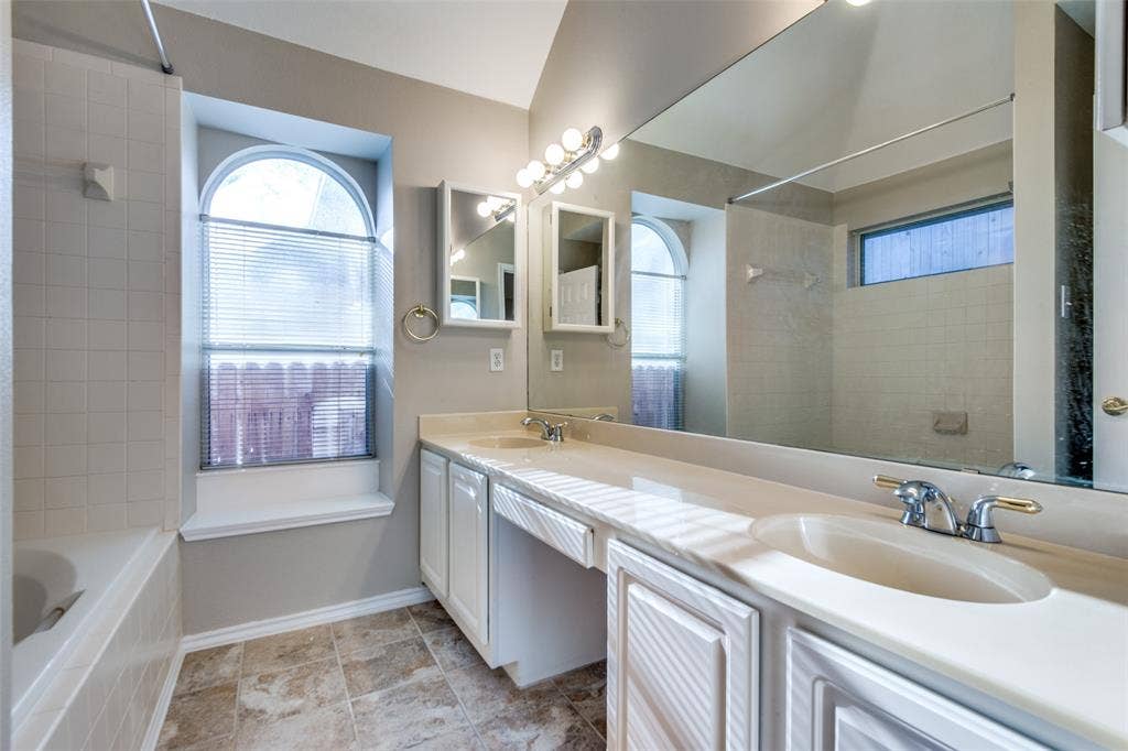 1913 Piney Creek Boulevard, Denton, TX 76205 Double vanity with integrated sinks, ample countertop space, full-width mirror, and dedicated vanity lighting
