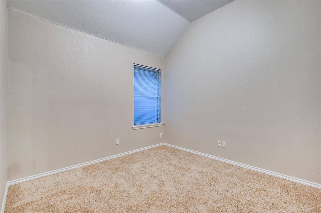 1913 Piney Creek Boulevard, Denton, TX 76205 Carpeted flooring with painted walls, a vaulted ceiling, and a single window