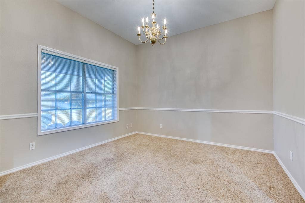 1913 Piney Creek Boulevard, Denton, TX 76205 Vaulted ceiling, decorative chandelier, large window with blinds, chair rail molding, and carpeting