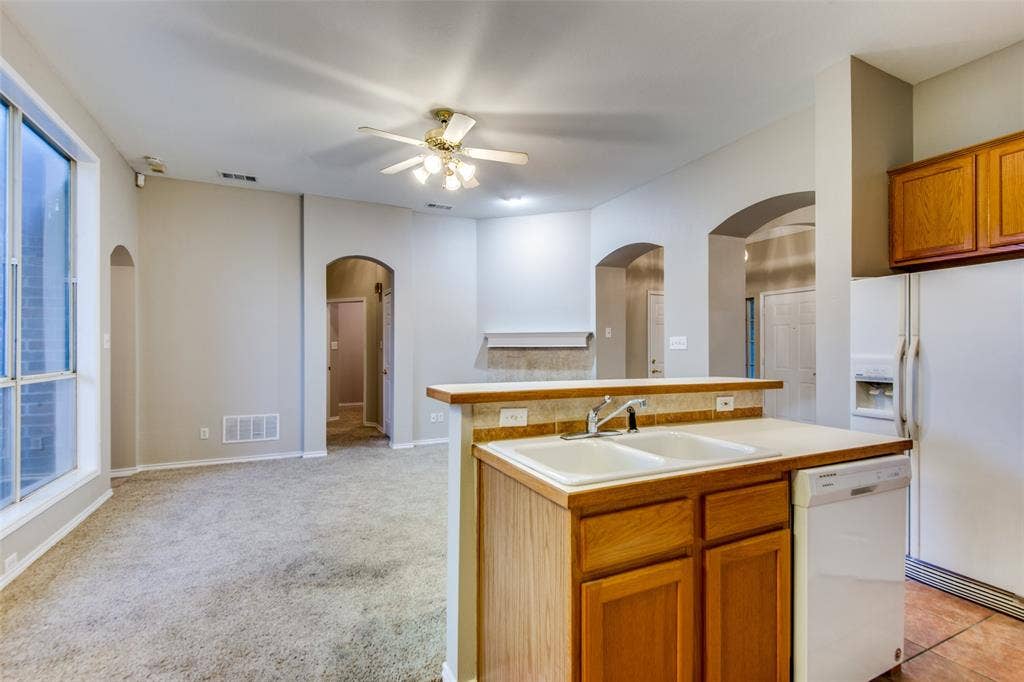 1913 Piney Creek Boulevard, Denton, TX 76205 Kitchen featuring a dual basin sink, light wood-finish cabinetry, and a dishwasher