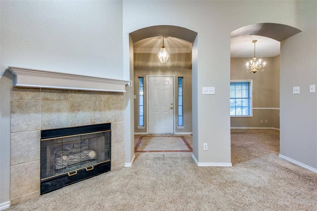 1913 Piney Creek Boulevard, Denton, TX 76205 Fireplace with a tile surround and mantel