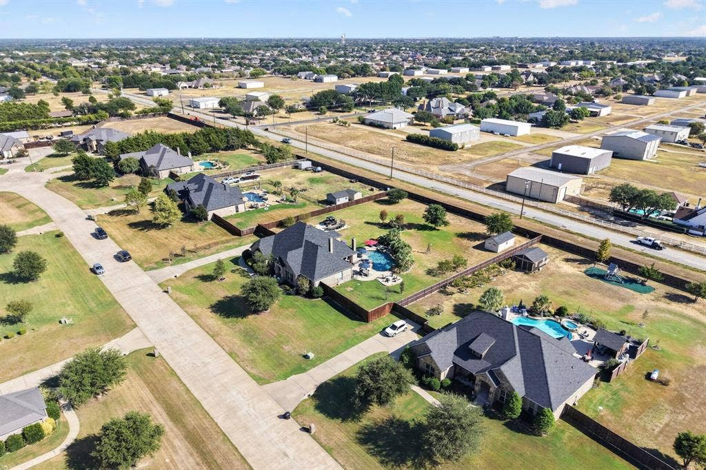 5020 Lindy Court, Midlothian, TX 76065 Aerial view showcasing two contemporary residences with dark architectural roofing, manicured lawns, and mature landscaping