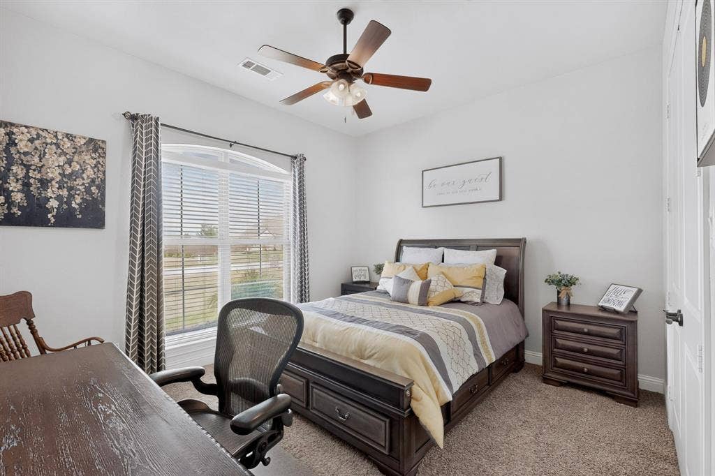5020 Lindy Court, Midlothian, TX 76065 Carpeted room with a ceiling fan, a window with blinds and drapes, and a white paneled door